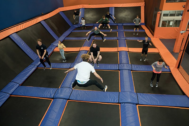 Image of people bouncing on a trampoline at Airborne Adventure Park.