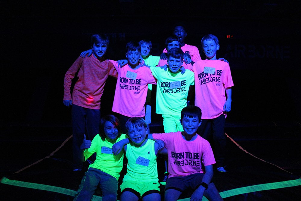 Image of boys wearing neon clothes for GLOW, a special event at Airborne Adventure Park